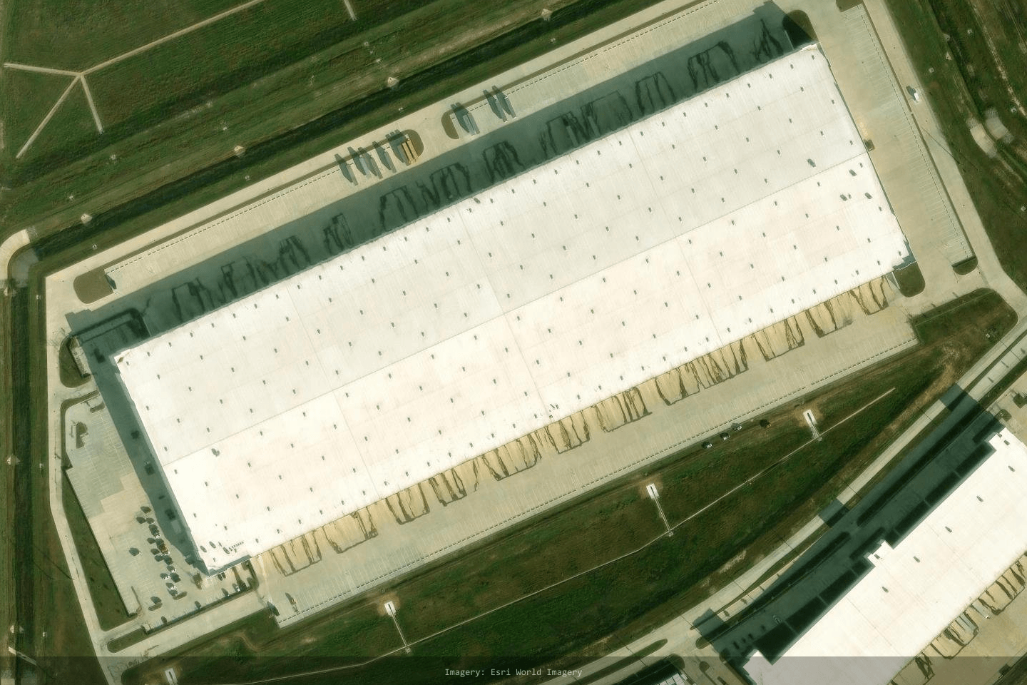 Satellite close-up of the PepsiCo Mixing Center in Brookshire TX, trailers at the docks, one of 30 flagship US sites mapped from satellite